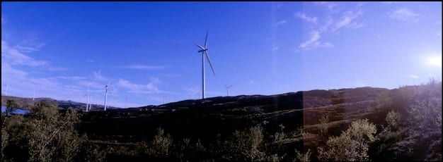 A collage featuring different renewable energy sources across the US: solar panel farms in Nevada, wind turbines in Iowa, hydroelectric dams in Washington State, and geothermal plants in California. The photos highlight the mix of renewable energy in the USA.
