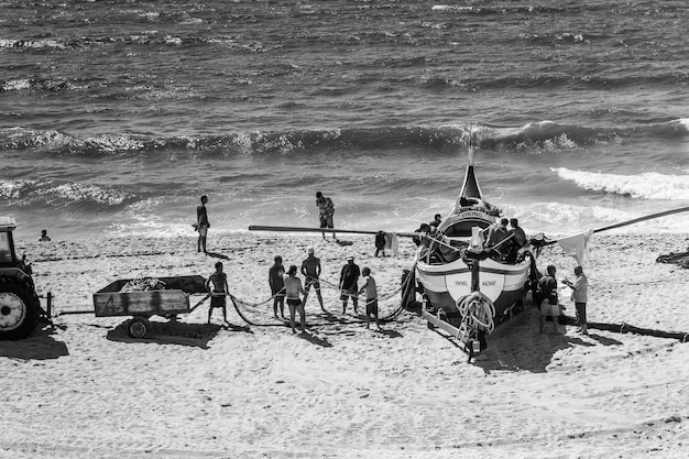 A black and white historical photograph of American soldiers landing on Normandy beach during World War II, showing the scale and intensity of US military involvement.