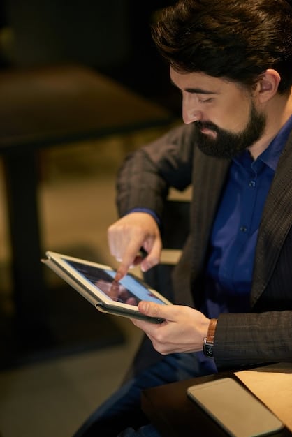 A close-up shot of a business owner using a digital tablet to analyze sales data, with a chart showing positive growth trends in the background. The image conveys data-driven decision-making and technological adaptation.